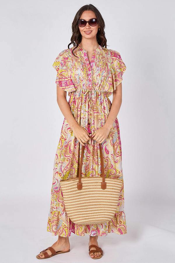 Woman wearing a colorful dress holding a striped bag on a white background