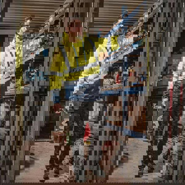 Scruffs High Visibility Mens Hi-Viz Work Pull Over Hoodie, bright yellow hoodie with reflective stripes being worn by a man in a workshop.