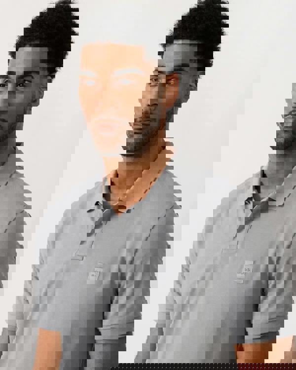 close up shot of a model wearing a BOSS Orange Passenger Mens Stretch-Cotton Slim-Fit Polo Shirt with Logo Patch in Silver 047