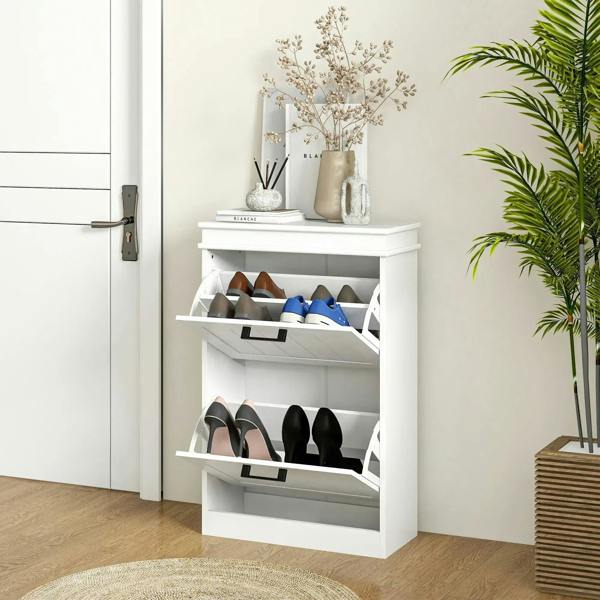 White two-drawer shoe cabinet with open shelves holding shoes; black drawer handles