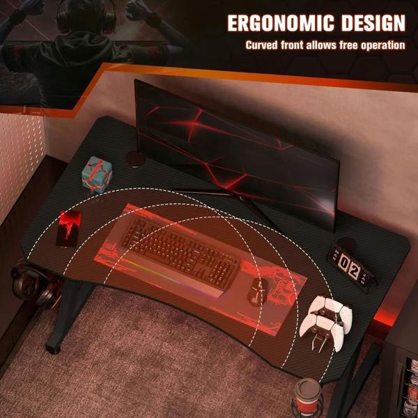 Black gaming desk with curved front edge and wide desktop for gaming setup