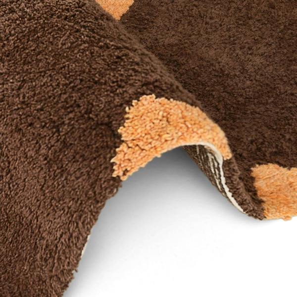 Close-up of a brown and orange textured rug corner on a white background