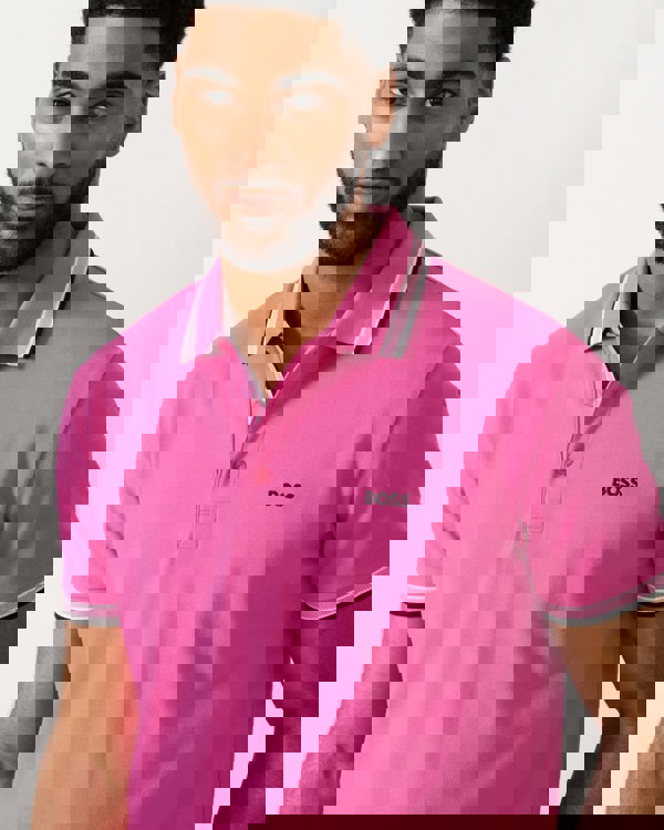 detail shot of a model wearing a BOSS Green Paddy Mens Cotton-Piqué Polo Shirt with Contrast Logo in Bright Pink