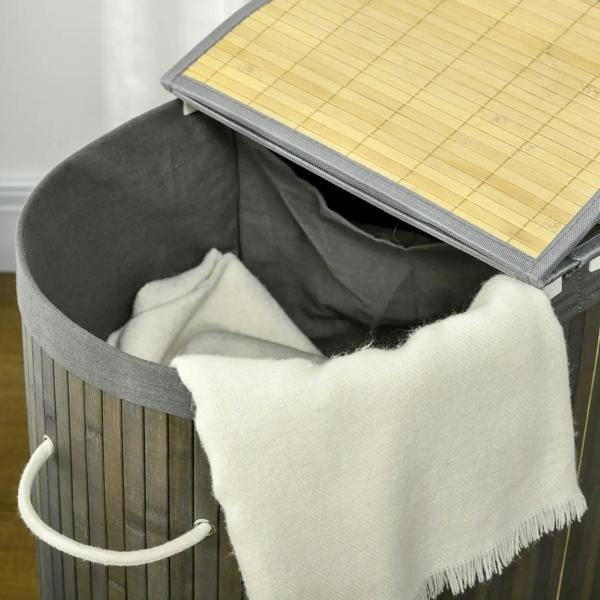 Grey bamboo laundry basket with lid, open liner holding light-colored clothes