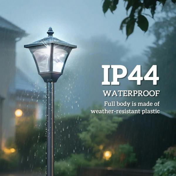 Black outdoor solar lamp post with lantern head under falling rain