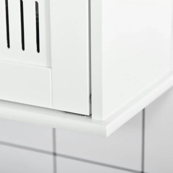 White cabinet door edge and handle area on a wall-mounted mirror cabinet, close-up