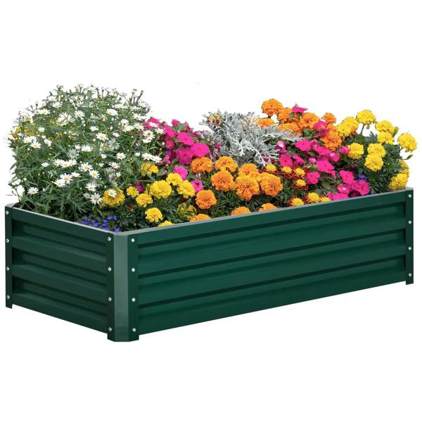 Green raised garden planter box with colorful flowers filling the bed