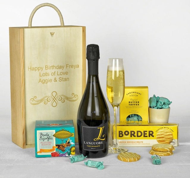 A bottle of Prosecco, biscuits, toffees and chocolates in a personalised wooden gift box