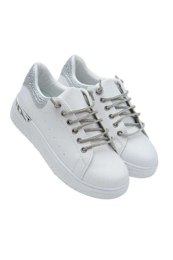 White sneakers with silver laces on a white background