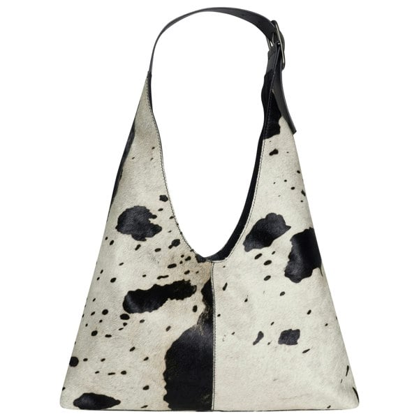 Image shows a cow hide bag that is black and white in colour. The bag is slightly hairy as it is made from real cow hide.