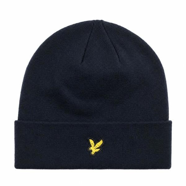 Dark navy Lyle & Scott merino wool beanie with a folded cuff and signature yellow eagle logo embroidery.