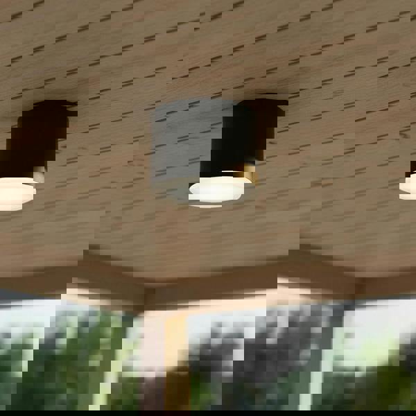 black waterproof outdoor downlight mounted on a wooden outdoor ceiling 