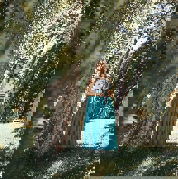 young girl wearing a teal flower girl dress