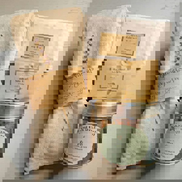 Ralph's Orchard eye pillow, tea packaging, and tea canister on a light background