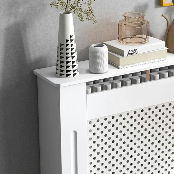 White radiator cover cabinet with perforated front grille, side handle cutouts, and top shelf.