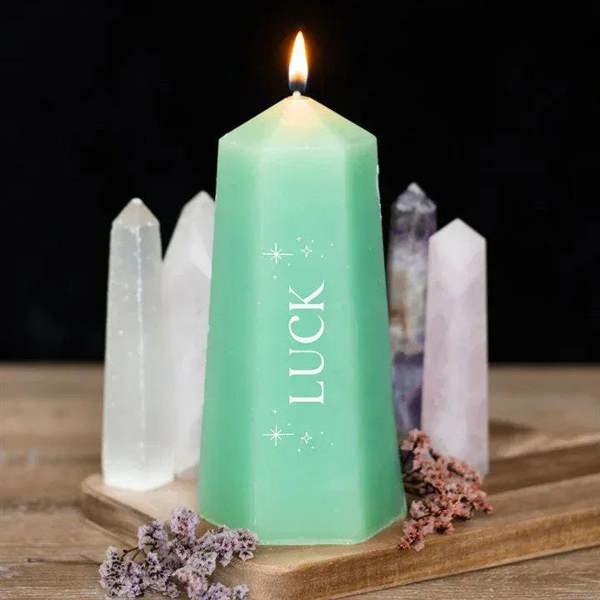 Lit Luck crystal candle, mint green taper on wooden tray with crystal clusters