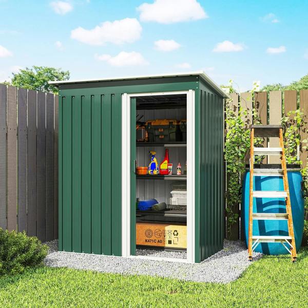 Green metal storage shed with sloped roof and open sliding door, tools on shelves
