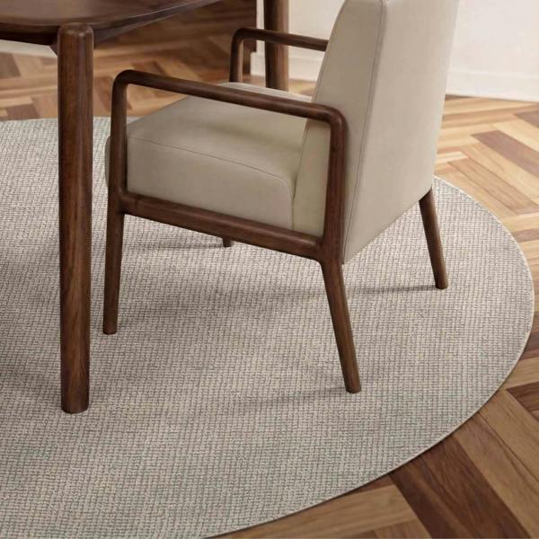 Beige armchair with wooden frame on a round gray rug