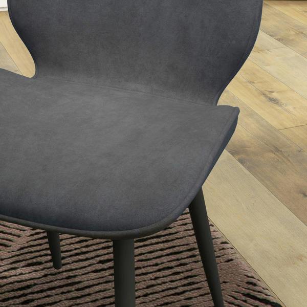 Grey velvet chair seat and armrest curve with black legs
