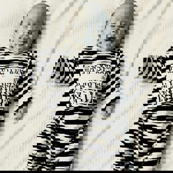 Smiling baby wearing Just Done 9 Months Inside baby grow