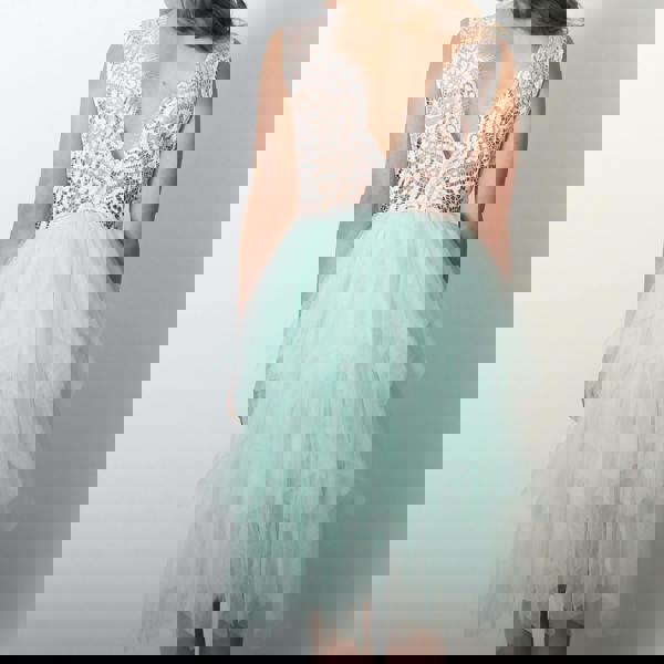 Mint green dress with lace top on a plain background