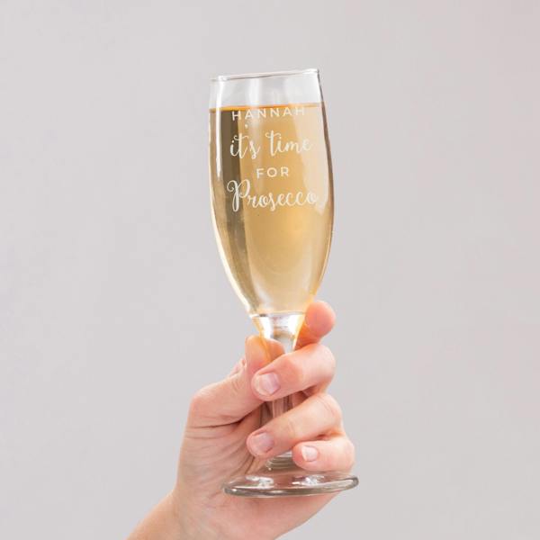 Person holding a Personalised 'It's Time for Prosecco' Flute filled with bubbly, engraved with the name HANNAH.