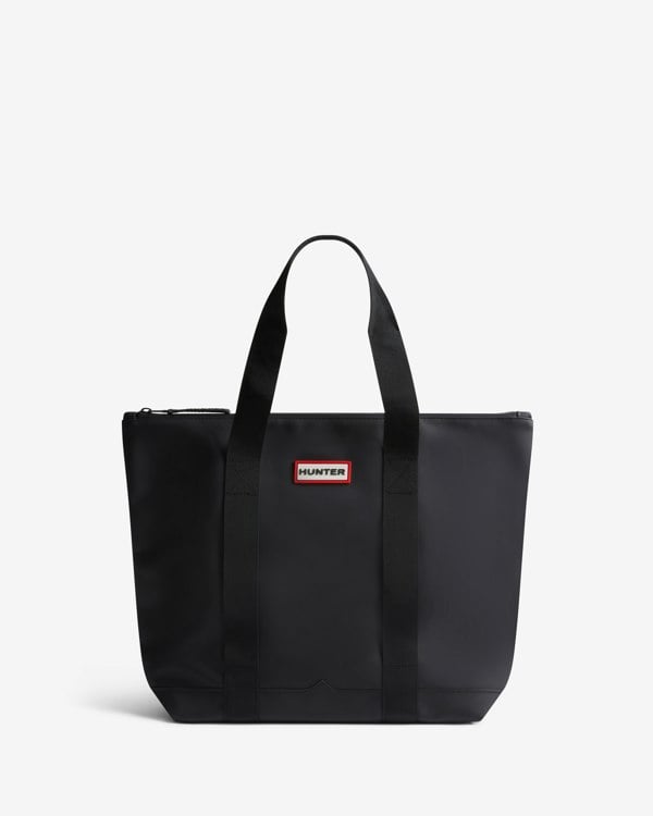 Black tote bag with a visible brand logo on a white background