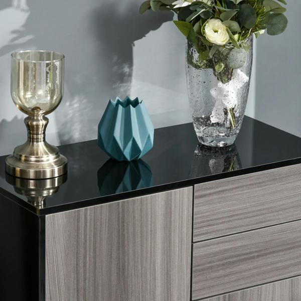 Sideboard top display with glossy black surface and light gray woodgrain cabinet doors