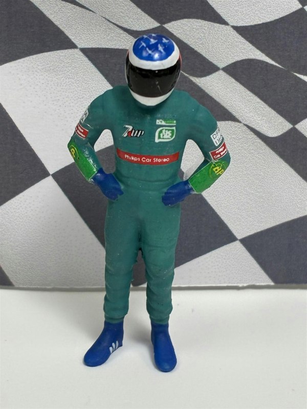 a toy figure of a race car driver