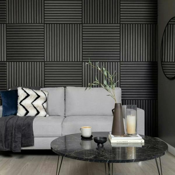 Modern living room with gray sofa, marble coffee table, and decorative wall panels.