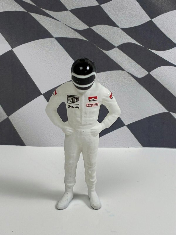 a toy figure in a race suit