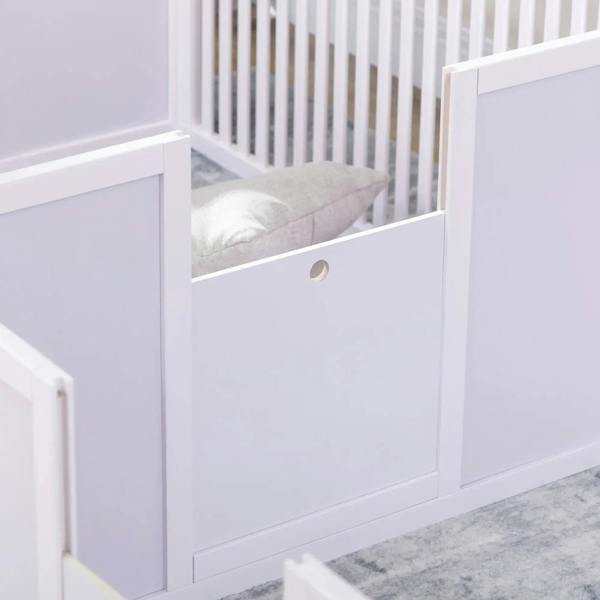 White playpen panel with slatted corner gate and cushioned bedding inside