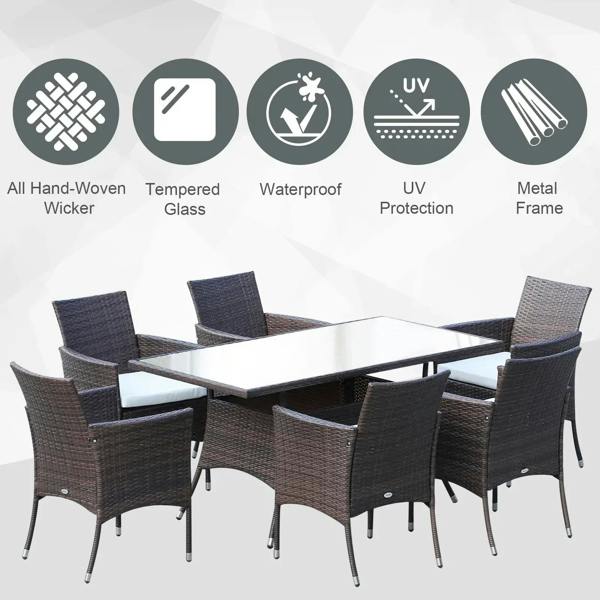 Brown rattan dining table set with six armchairs and white seat cushions