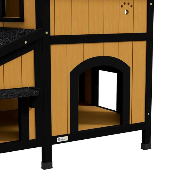 Yellow wooden cat house front with arched doorway window, black frame, and roof overhang