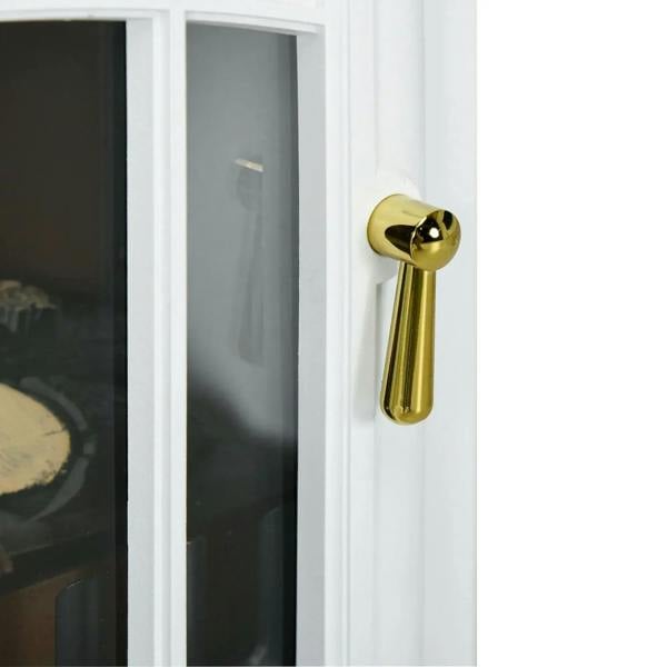White fireplace stove door edge with gold handle detail next to glass flame window