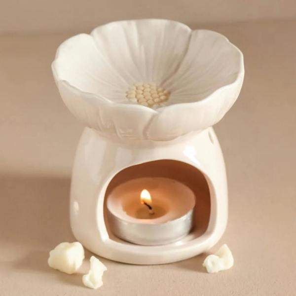 Pink Blossom ceramic wax melt burner shaped like a flower with a lit tea light inside on a neutral background by Abode Home & Gifts