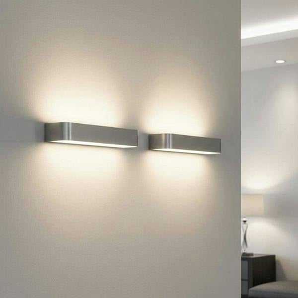 Silver up down sconce indoor showing two alongside on a neutral coloured wall in a modern home
