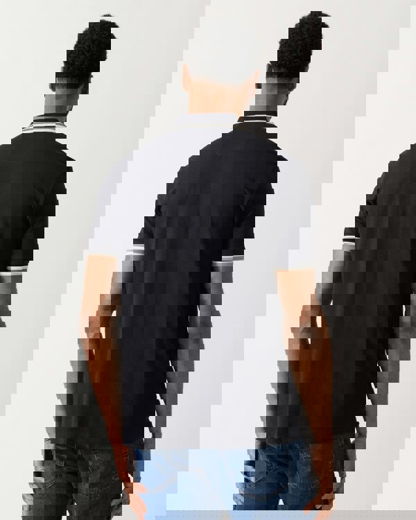 back shot of a Model wearing a BOSS Green Paddy Mens Cotton-Piqué Polo Shirt with Contrast Logo in Medium Blue