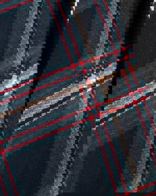 Close-up of a plaid fabric with 'BOSS' branding.