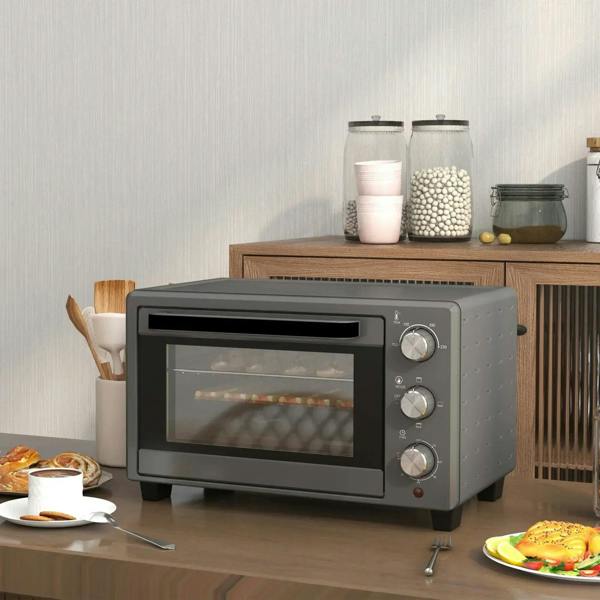 Grey mini countertop oven with front glass viewing window and control knobs