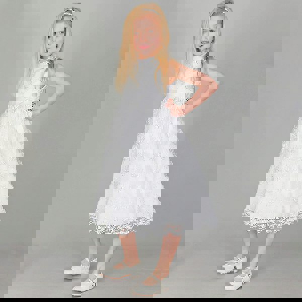 Girl posing in white uk flower girl dress