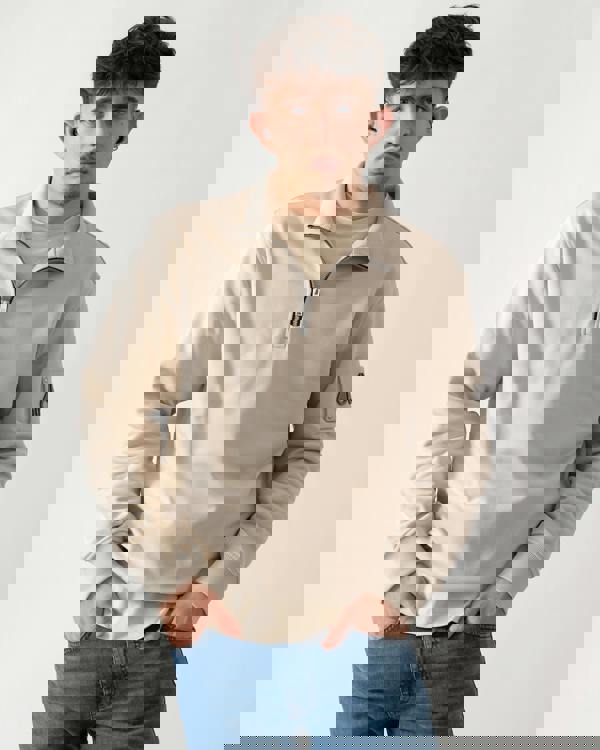 Studio shot of a model wearing a Moose Knuckles Hartsfield Mens 1/4 Zip Sweatshirt in Alabaster 1705