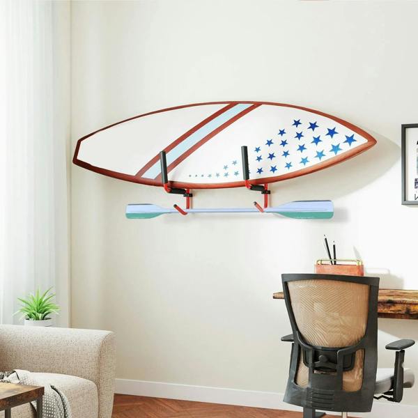 Red wall-mounted kayak/canoe storage rack holding a surfboard-style board with black pads