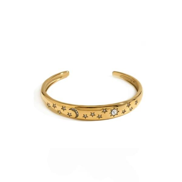 Gold bracelet with star and moon designs on a white background