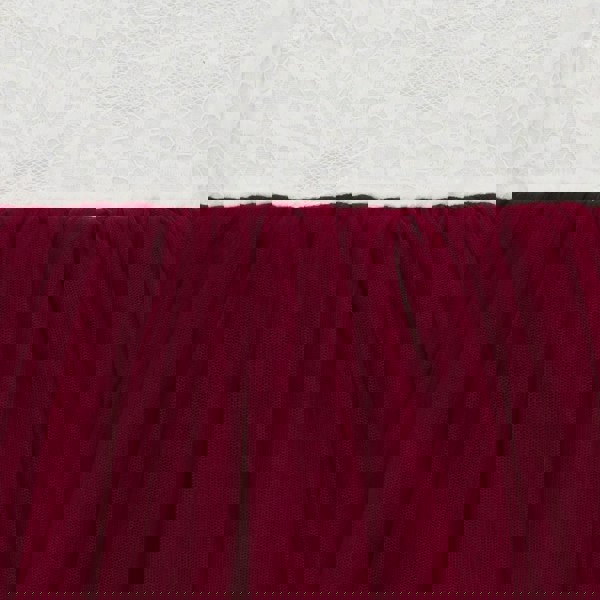 Close-up of burgundy fabric with a textured white background