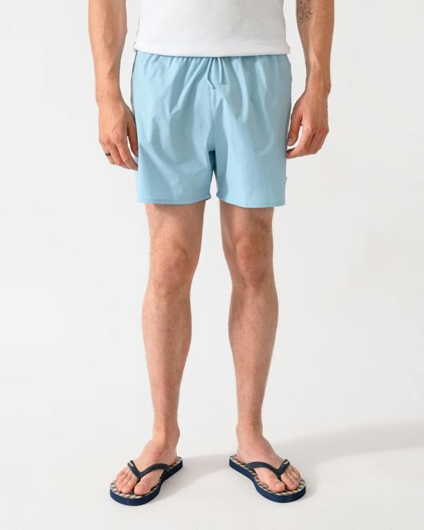 front shot of a model wearing a pair of Emporio Armani Mens Swim Shorts with Eagle Logo in Sky
