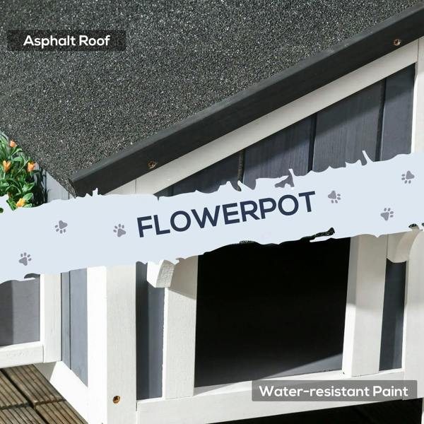 Grey wooden cat house underside view with asphalt-textured roof and flower pot opening