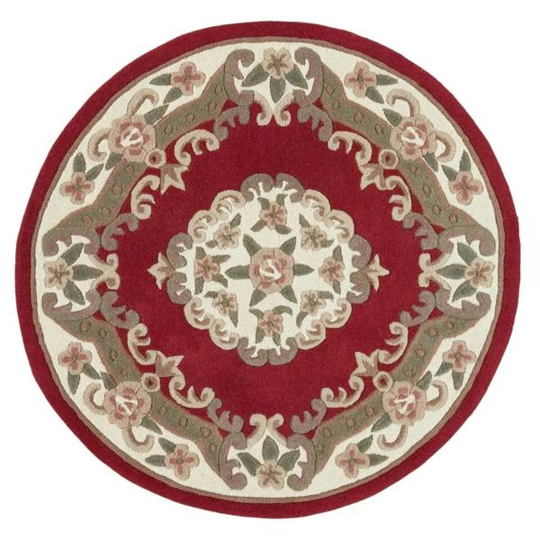 Round red area rug with floral patterns on a white background