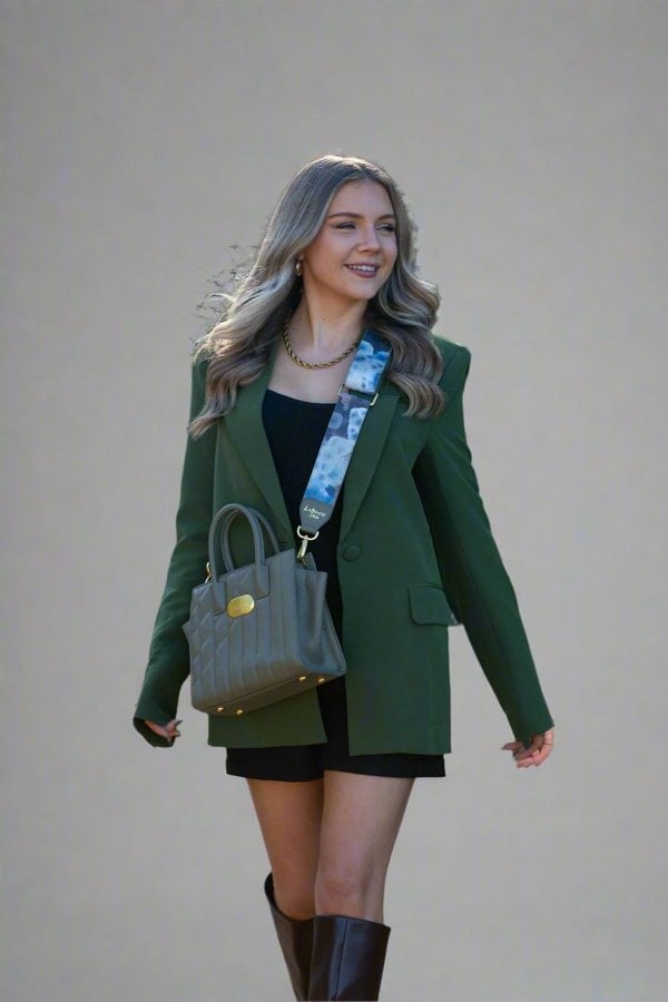 Girl wearing a Vegan Sustainable handbag with a coloured strap in Greens and Blues