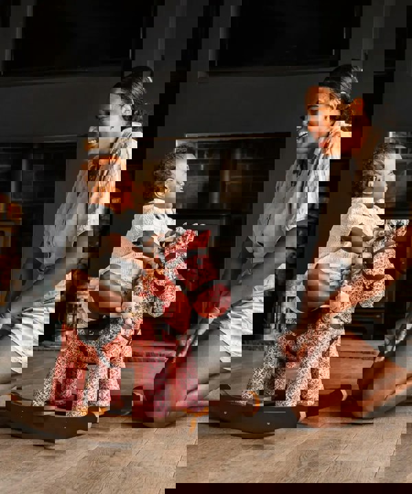 little girl and mum playing with cooper and beau rocking horse